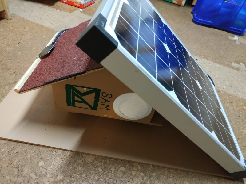 In the picture you can see the fully assembled SAM with the MAI logo on front and a solar panel on its roof.